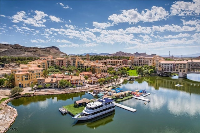 birds eye view of property with a water and mountain view