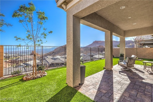 view of patio with a fenced backyard and a mountain view
