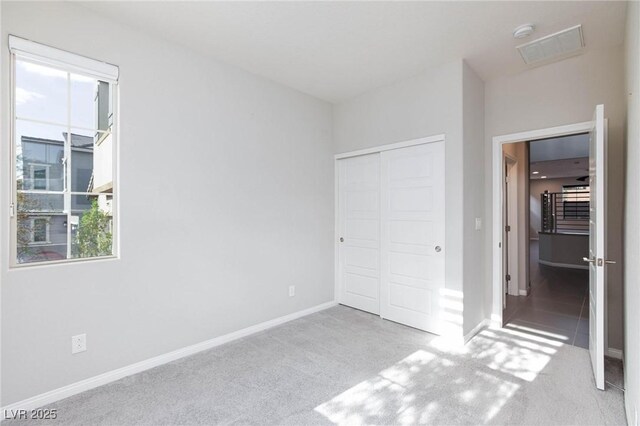 26 Lilla Rosa St, Henderson, NV 89011 - unfurnished bedroom with carpet flooring, a closet, and multiple windows