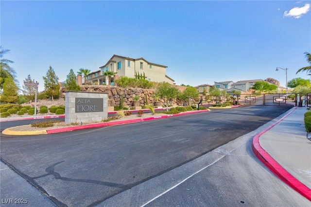 26 Lilla Rosa St, Henderson, NV 89011 - view of road featuring sidewalks, a gated entry, curbs, and street lighting