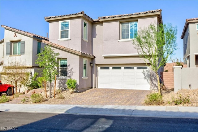 26 Lilla Rosa St, Henderson, NV 89011 - mediterranean / spanish house with stucco siding, decorative driveway, a tiled roof, and an attached garage