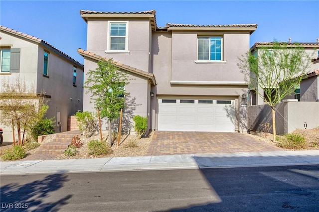 26 Lilla Rosa St, Henderson, NV 89011 - mediterranean / spanish house featuring fence, a tiled roof, decorative driveway, stucco siding, and a garage