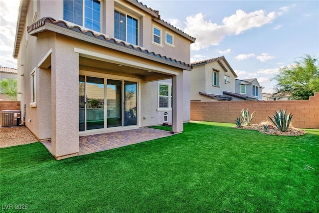 26 Lilla Rosa St, Henderson, NV 89011 - rear view of house featuring stucco siding, fence, a patio area, cooling unit, and a lawn