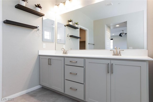 26 Lilla Rosa St, Henderson, NV 89011 - bathroom with baseboards, tile patterned floors, double vanity, and a sink