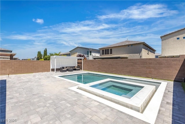 view of swimming pool featuring a fenced backyard, a patio area, and a pool with connected hot tub