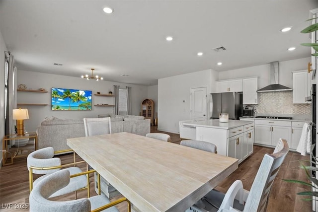 dining room with recessed lighting, visible vents, an inviting chandelier, and dark wood-style floors