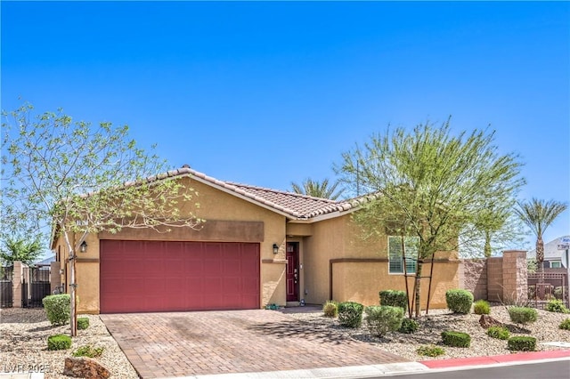 ranch-style house with an attached garage, a tiled roof, stucco siding, and fence