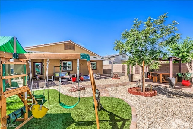 view of jungle gym with a fenced backyard and a patio area