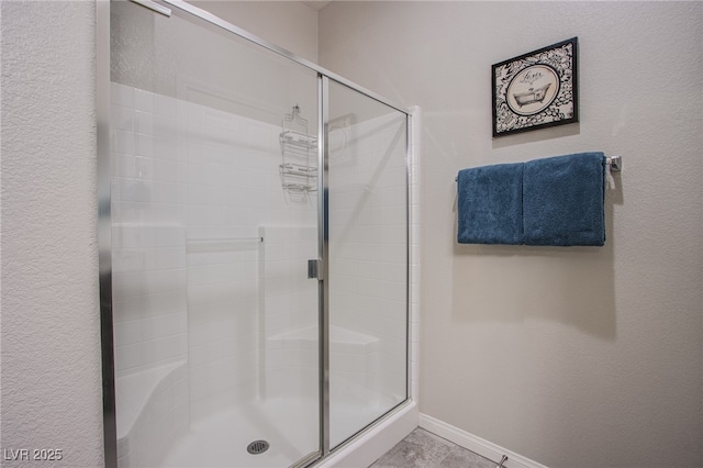 10470 Irish Cliffs Ct, Las Vegas, NV 89149 - bathroom featuring a textured wall, a stall shower, and baseboards