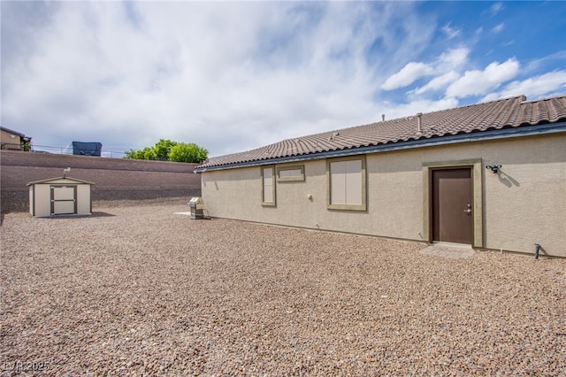10470 Irish Cliffs Ct, Las Vegas, NV 89149 - view of property exterior with stucco siding, a storage unit, a tiled roof, and an outdoor structure