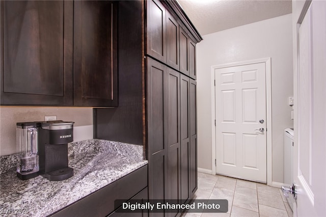 10470 Irish Cliffs Ct, Las Vegas, NV 89149 - interior space featuring light tile patterned flooring, cabinet space, a textured ceiling, and baseboards
