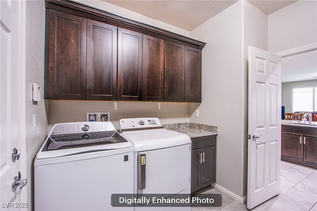 10470 Irish Cliffs Ct, Las Vegas, NV 89149 - laundry area featuring light tile patterned floors, a sink, baseboards, separate washer and dryer, and cabinet space