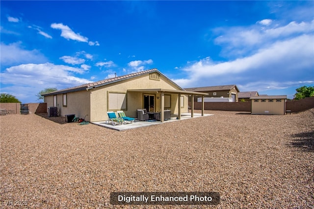 10470 Irish Cliffs Ct, Las Vegas, NV 89149 - rear view of house with a fenced backyard, stucco siding, an outbuilding, a patio, and a shed