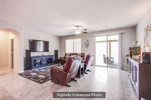10470 Irish Cliffs Ct, Las Vegas, NV 89149 - living room with baseboards, visible vents, arched walkways, and a ceiling fan
