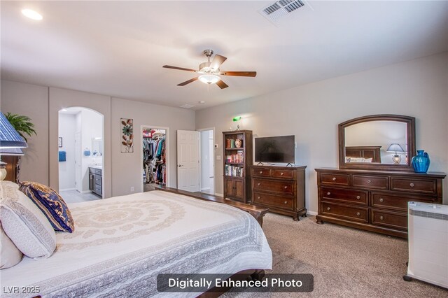 10470 Irish Cliffs Ct, Las Vegas, NV 89149 - bedroom with ensuite bath, visible vents, arched walkways, carpet floors, and a spacious closet