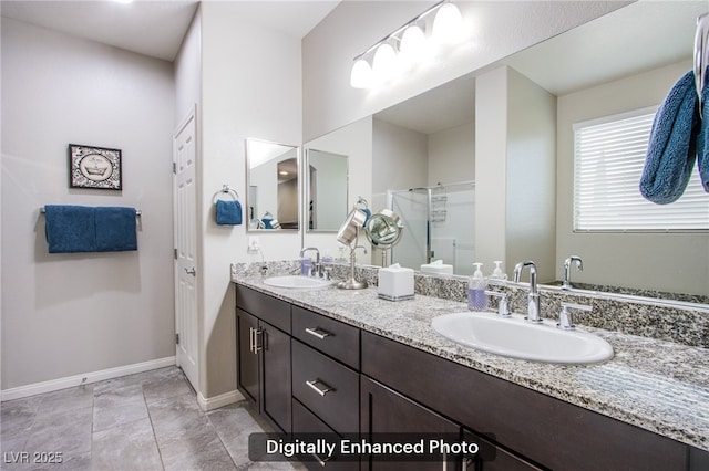 10470 Irish Cliffs Ct, Las Vegas, NV 89149 - bathroom featuring double vanity, a sink, a shower stall, and baseboards