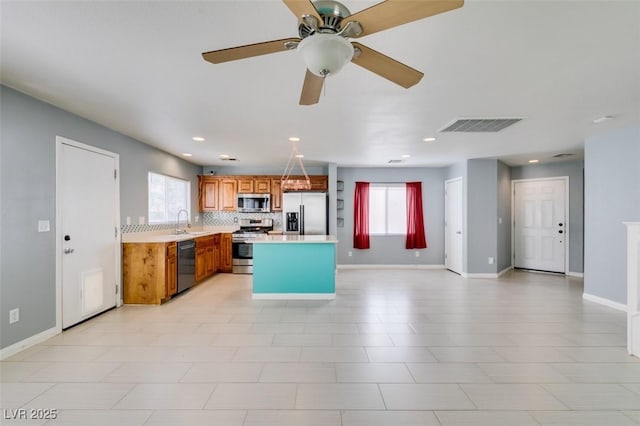 kitchen featuring plenty of natural light, light countertops, visible vents, and appliances with stainless steel finishes