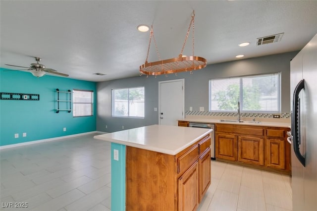kitchen with light countertops, visible vents, appliances with stainless steel finishes, and a sink