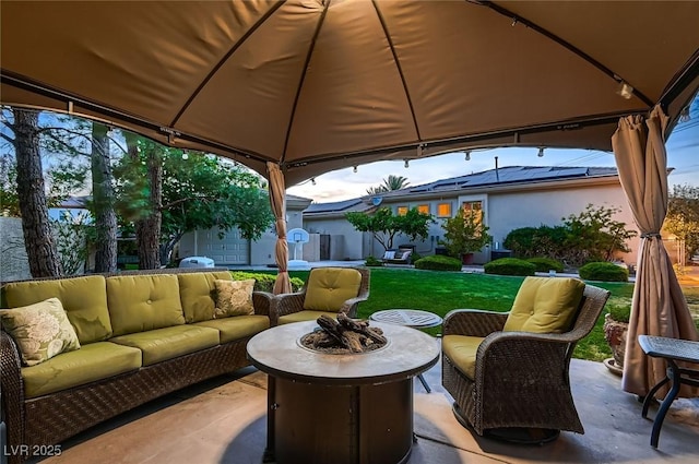 view of patio featuring an outdoor living space with a fire pit and a gazebo