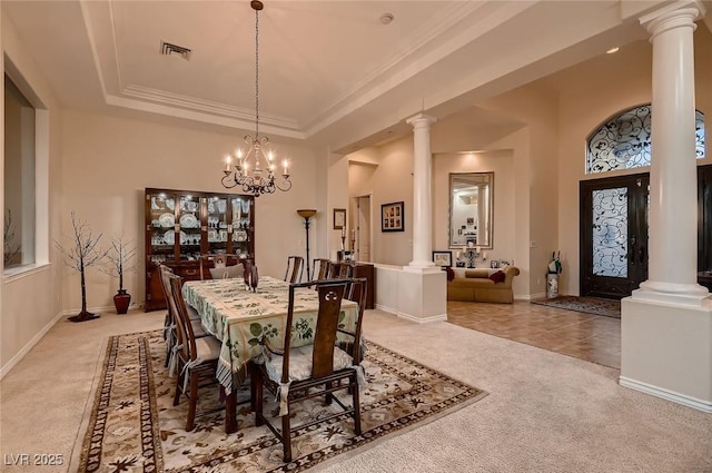 dining room featuring visible vents, decorative columns, a raised ceiling, and carpet flooring