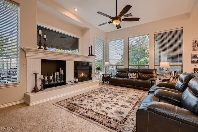 living area featuring a tiled fireplace, recessed lighting, carpet, baseboards, and a ceiling fan