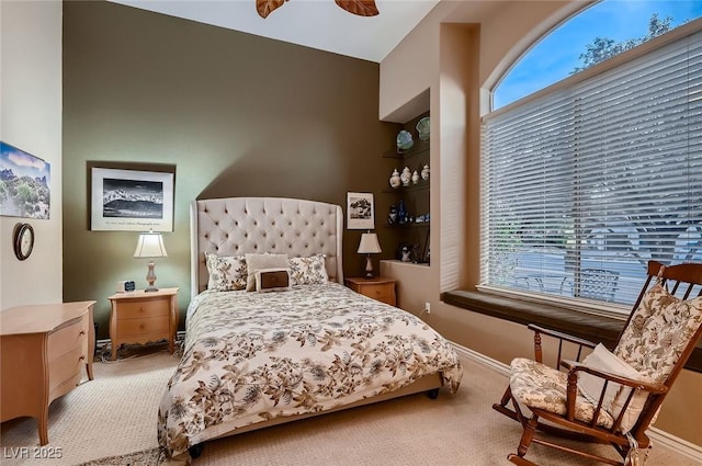 carpeted bedroom featuring baseboards