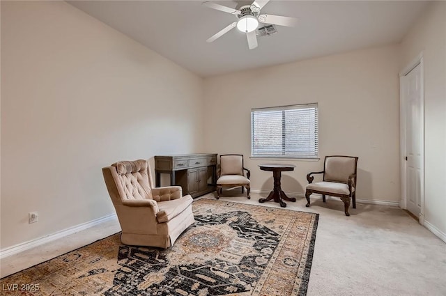 living area with ceiling fan, light carpet, visible vents, and baseboards