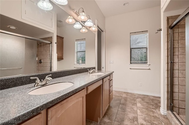 full bath featuring a shower stall, tile patterned flooring, double vanity, and a sink
