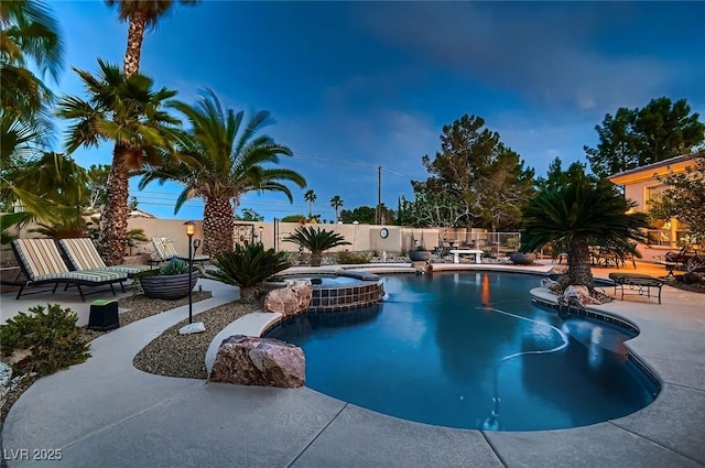 view of swimming pool with a patio area, a pool with connected hot tub, and a fenced backyard