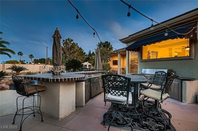 view of patio with fence and outdoor wet bar