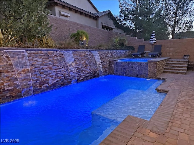view of swimming pool featuring a fenced in pool, a hot tub, and fence