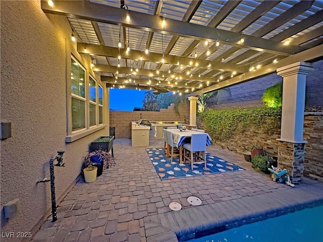 view of patio featuring an outdoor kitchen, a pergola, a fenced backyard, and a swimming pool