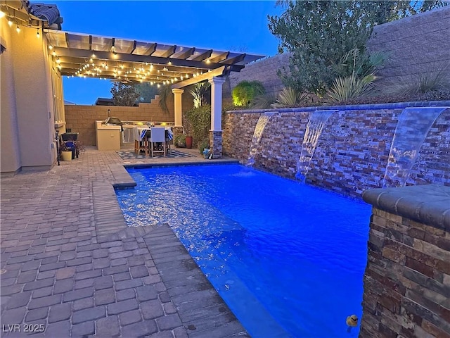 view of swimming pool with an outdoor kitchen, a fenced in pool, a pergola, a fenced backyard, and a patio area