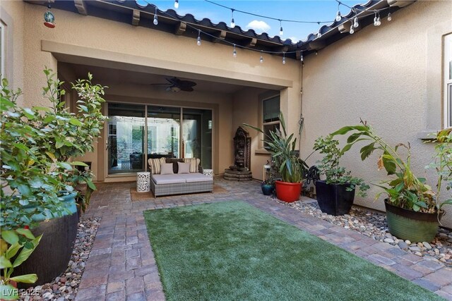view of yard with ceiling fan and a patio
