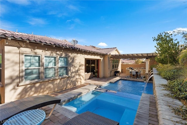 back of property featuring fence, a pergola, stucco siding, a patio, and a pool with connected hot tub