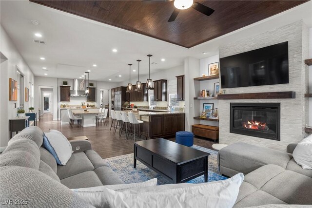 living room featuring wood finished floors, ceiling fan, wooden ceiling, visible vents, and recessed lighting