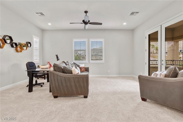 living area with french doors, visible vents, and light colored carpet