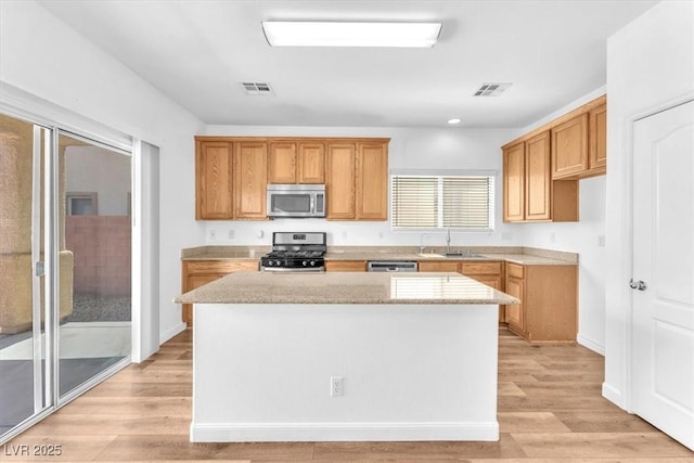 5060 Blue Rose St, North Las Vegas, NV 89081 - kitchen with visible vents, appliances with stainless steel finishes, a center island, and a sink