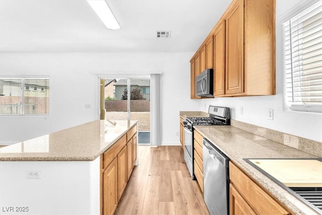 5060 Blue Rose St, North Las Vegas, NV 89081 - kitchen featuring plenty of natural light, visible vents, light wood-style floors, and appliances with stainless steel finishes