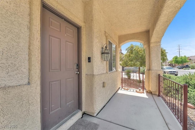 5060 Blue Rose St, North Las Vegas, NV 89081 - doorway to property with stucco siding and covered porch