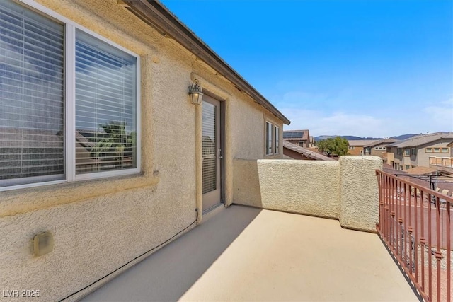 5060 Blue Rose St, North Las Vegas, NV 89081 - view of side of property with a balcony, a residential view, and stucco siding