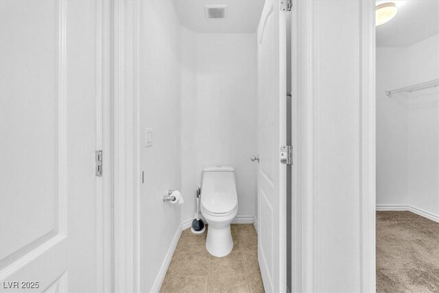 5060 Blue Rose St, North Las Vegas, NV 89081 - bathroom featuring tile patterned flooring, visible vents, toilet, and baseboards