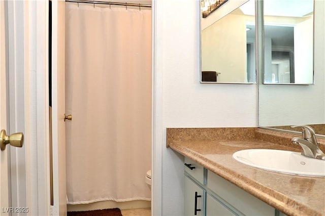 bathroom featuring toilet, a shower with curtain, and vanity