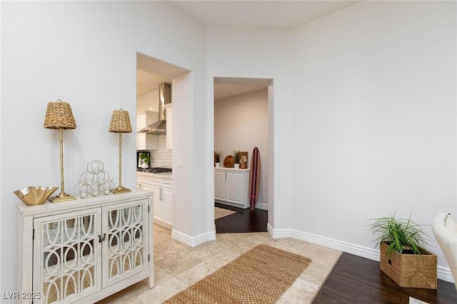 hall featuring baseboards