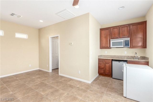 2489 Black River Falls Dr, Henderson, NV 89044 - kitchen featuring light countertops, stainless steel microwave, visible vents, and dishwasher