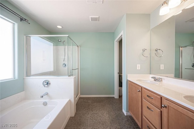 full bathroom with plenty of natural light, visible vents, a sink, and a shower stall