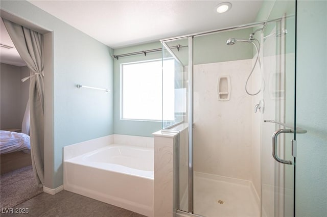 bathroom with a shower stall and a garden tub