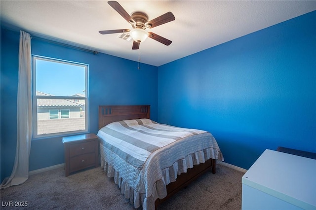 carpeted bedroom with baseboards and ceiling fan