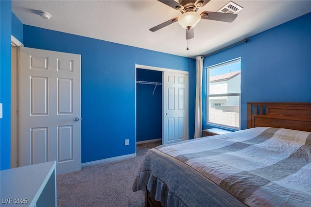 carpeted bedroom featuring ceiling fan, baseboards, visible vents, and a closet
