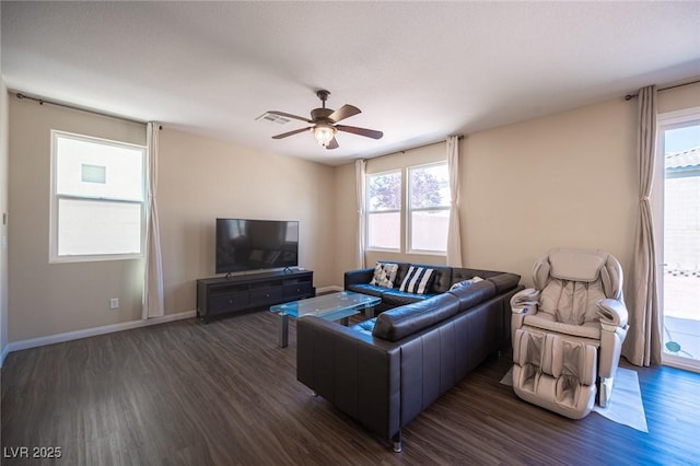 living room with baseboards, visible vents, ceiling fan, and dark wood finished floors